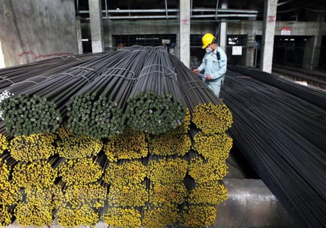 An employee is at work at a steel mill in Vietnam - PHOTO: VNA